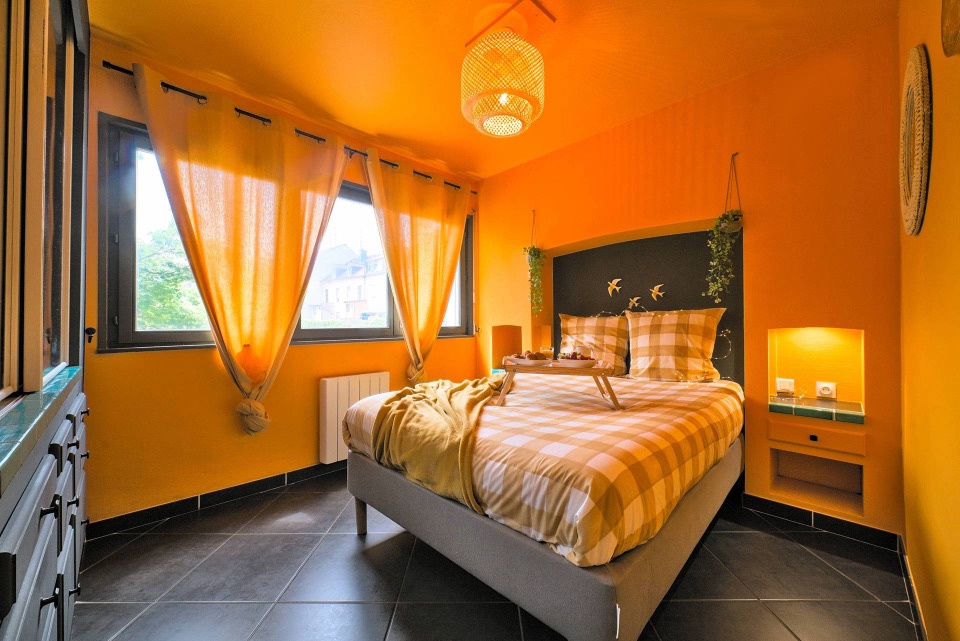 Warm-toned rental bedroom with a breakfast tray laid out on the bed