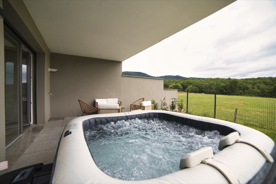Hot tub on a covered terrace overlooking the Vosges hills